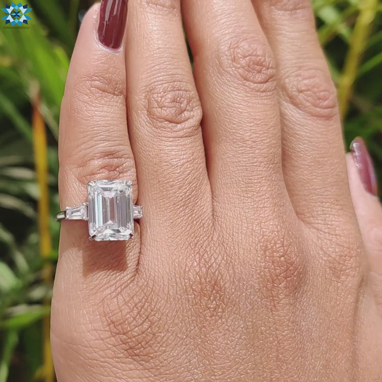 Moissanite ring with prong setting and three stone design.
