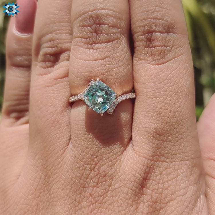 Moissanite engagement ring in rose gold with modern prong structure.

