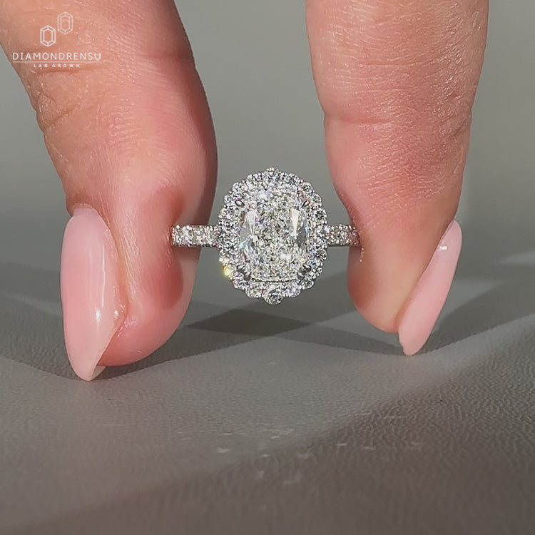 Cushion diamond ring with milgrain details and pave band.