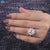 Old mine cushion cut engagement ring in white gold with claw prongs.
