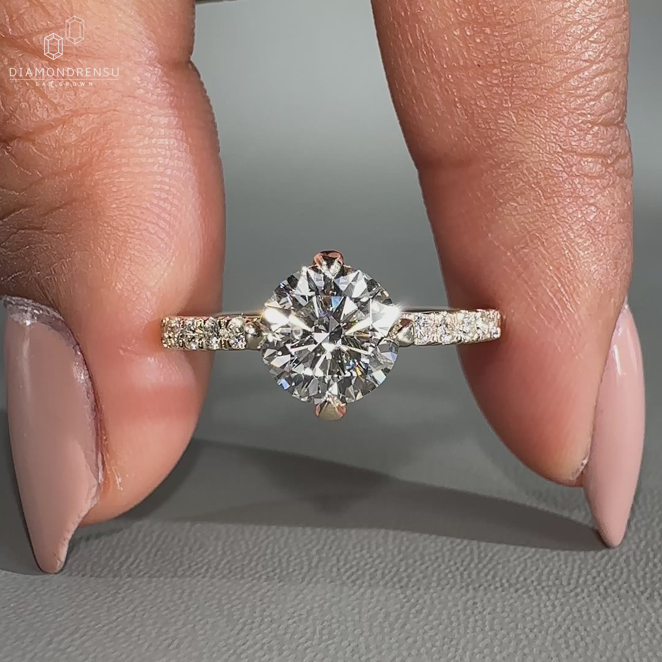 Round diamond engagement ring featuring round diamond pave band.
