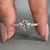 Round diamond engagement ring featuring round diamond pave band.
