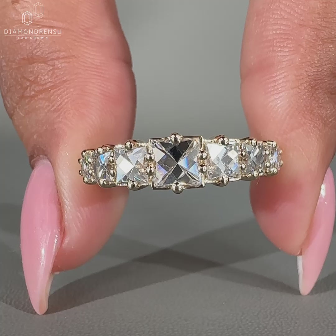 7 stone diamond band featuring lab grown diamonds in a prong setting.