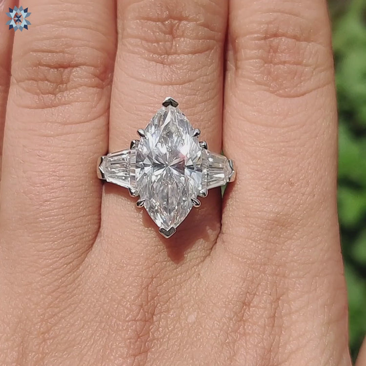 Proposal ring with bullet and marquise moissanite stones in white gold.
