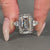 Three stone emerald ring with hidden halo detail.