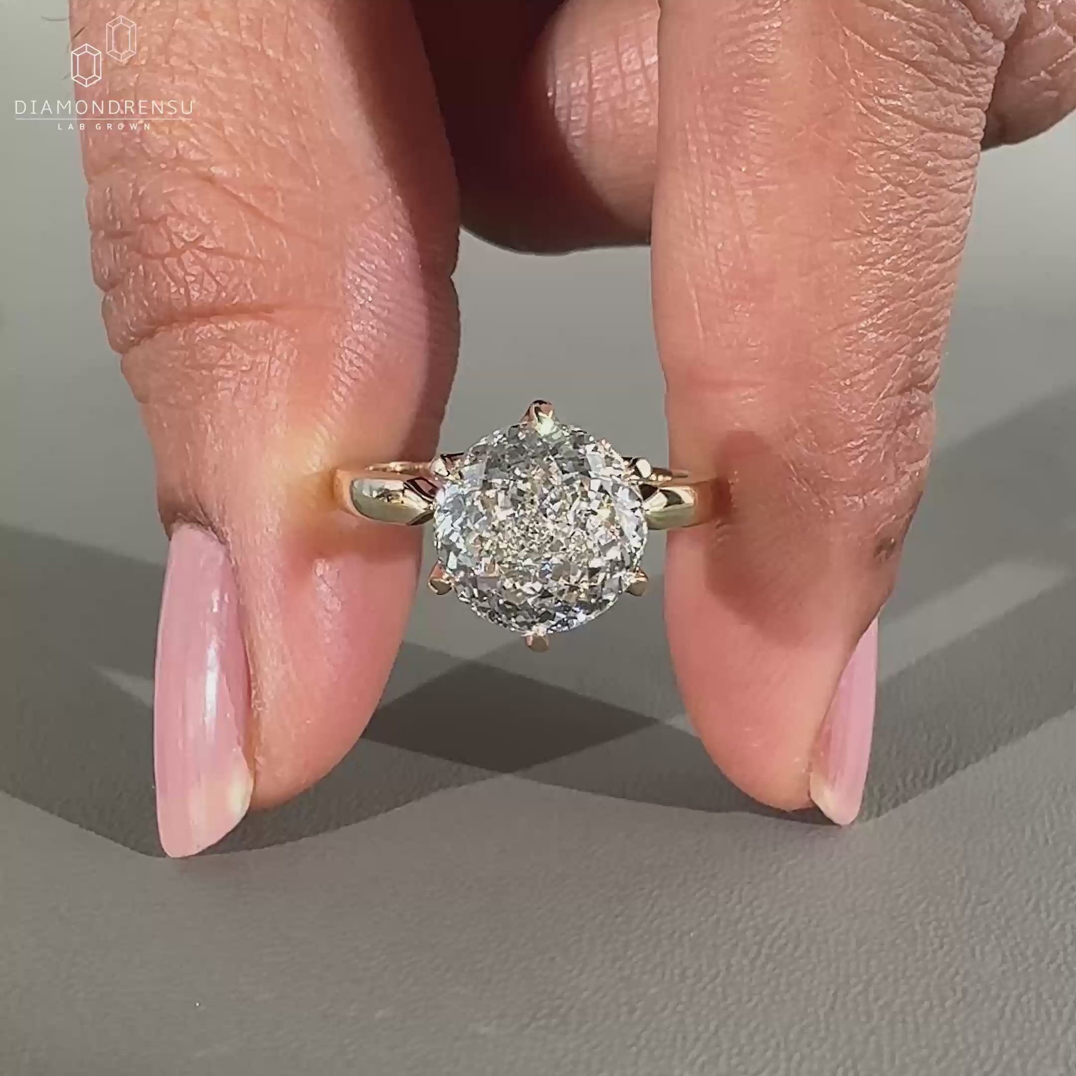 Round cut diamond ring featuring a solitaire design.
