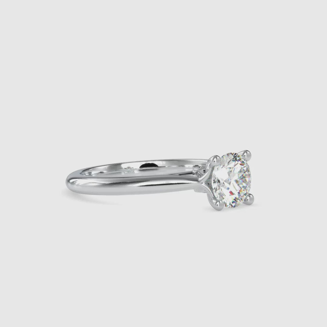 Handmade knife edge engagement ring with a round brilliant cut diamond in a cathedral setting for timeless beauty.
