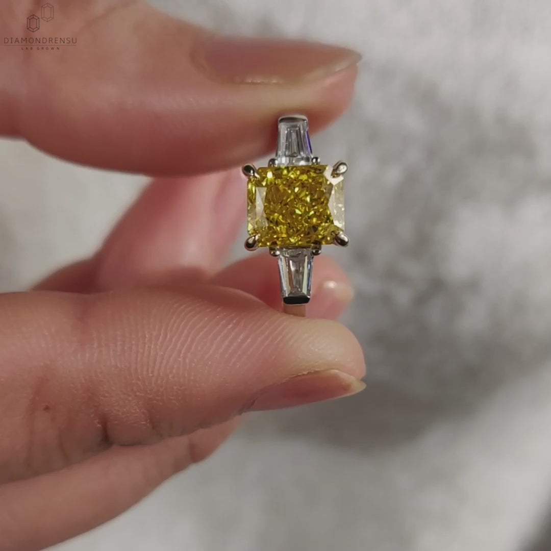 Handmade vivid yellow diamond ring in a radiant cut claw prong setting.