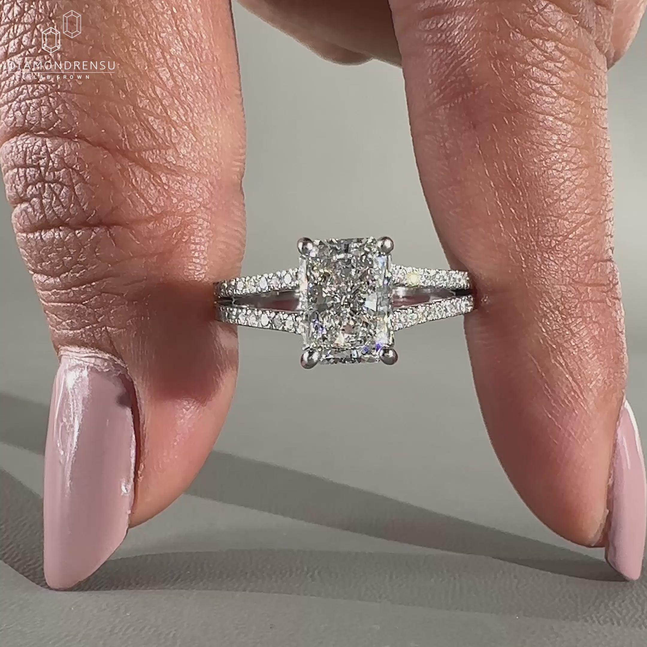 Hidden halo engagement ring with a split shank pavé setting.
