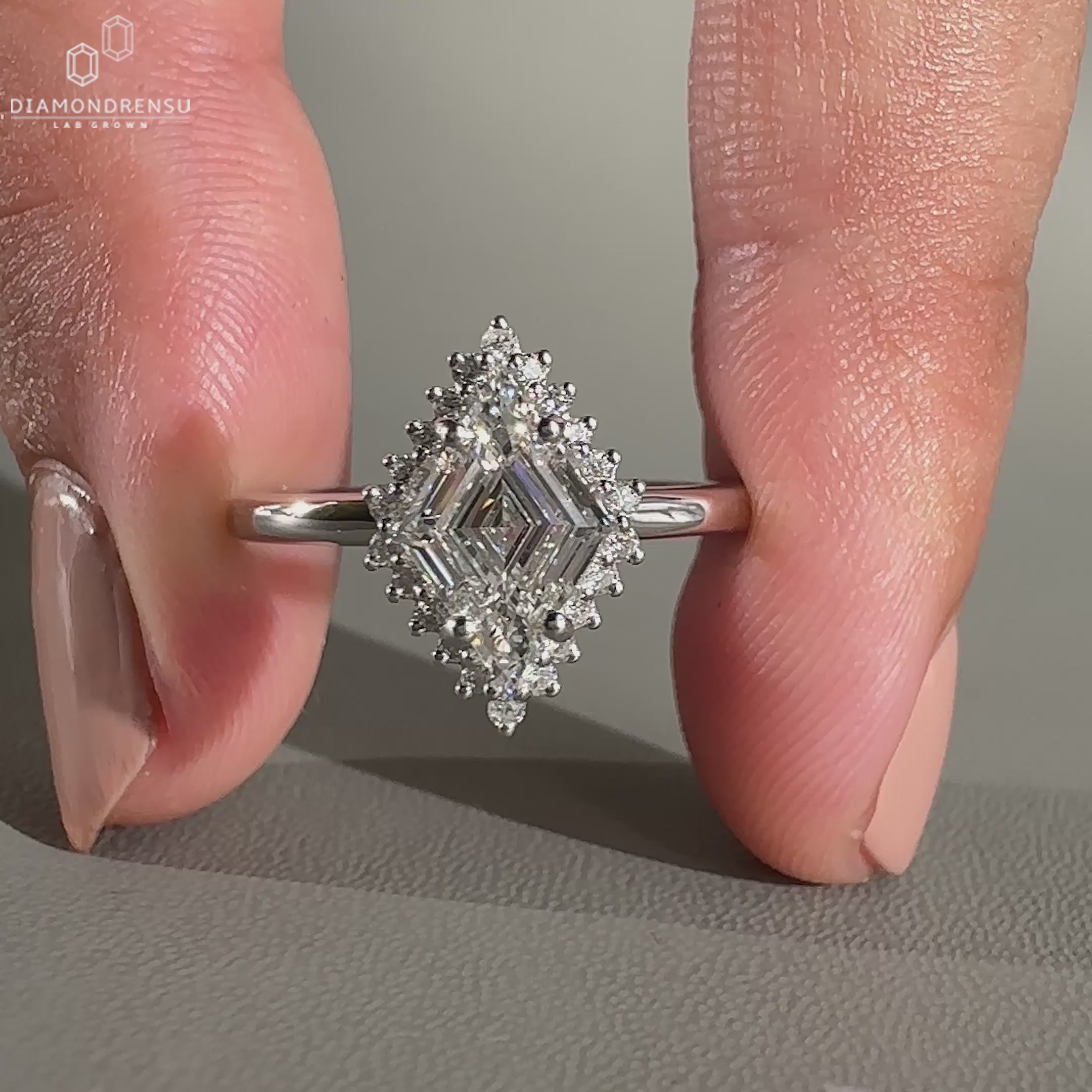 Lozenge cut diamond ring in white gold with four prong set design.
