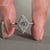 Lozenge cut diamond ring in white gold with four prong set design.
