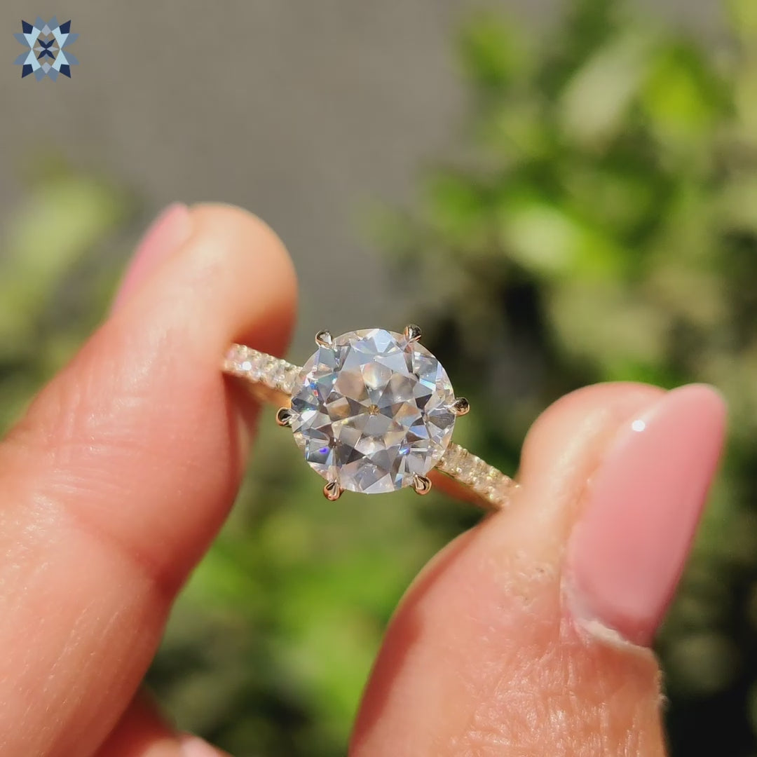 Pave engagement ring featuring hidden halo and bridge accents in yellow gold.

