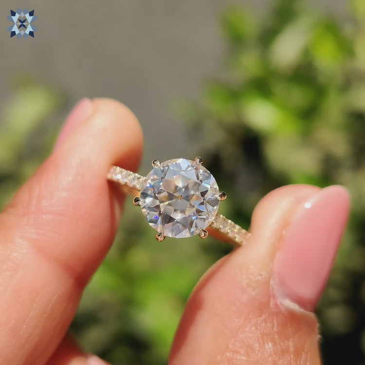 Pave engagement ring featuring hidden halo and bridge accents in yellow gold.
