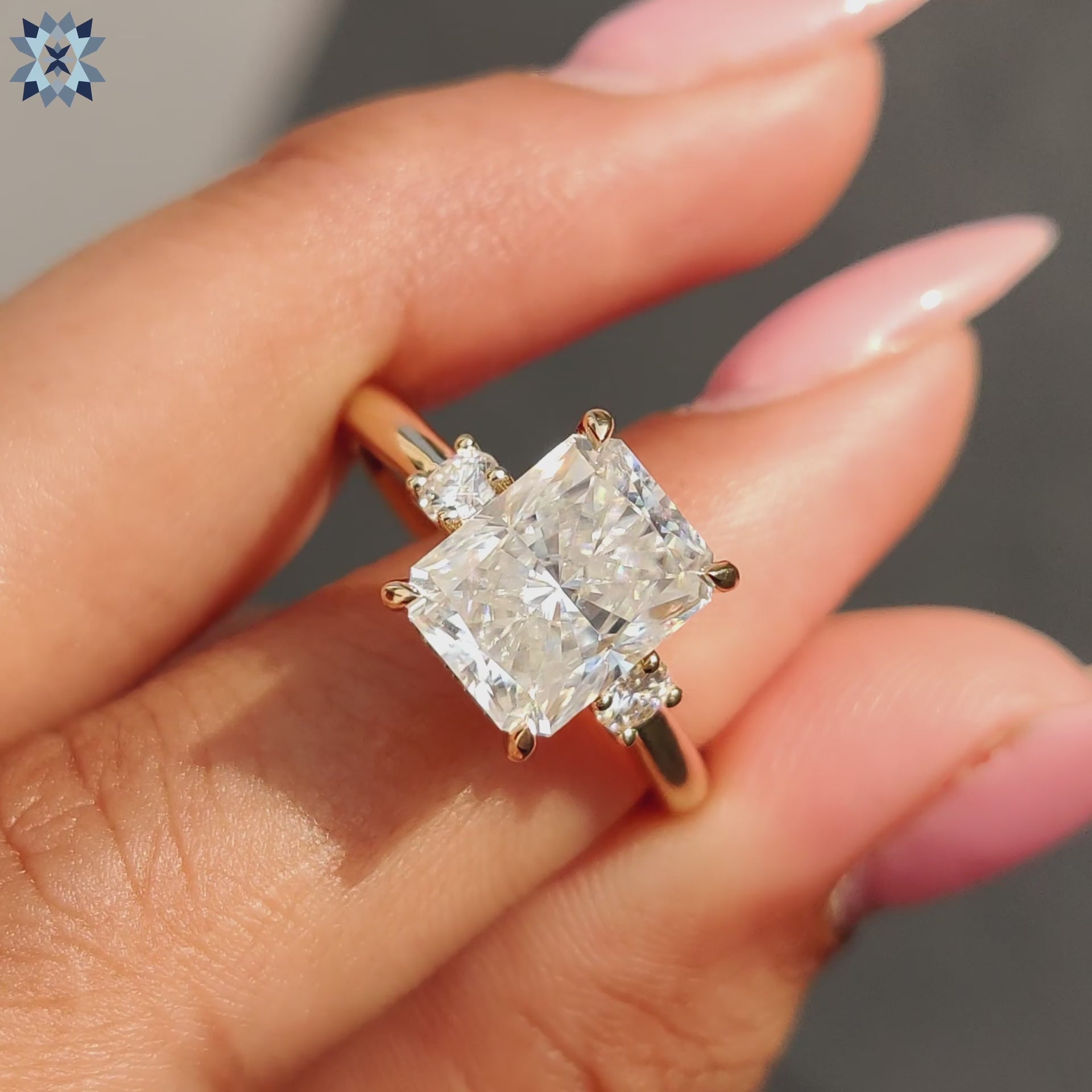 Radiant cut centre stone ring crafted in yellow gold with a hidden halo.
