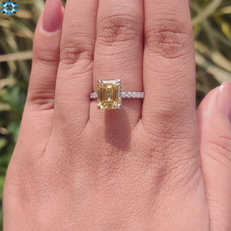 Engagement ring with canary moissanite and white gold pave band.
