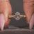 Oval cut ring with Art Deco style and milgrain details.