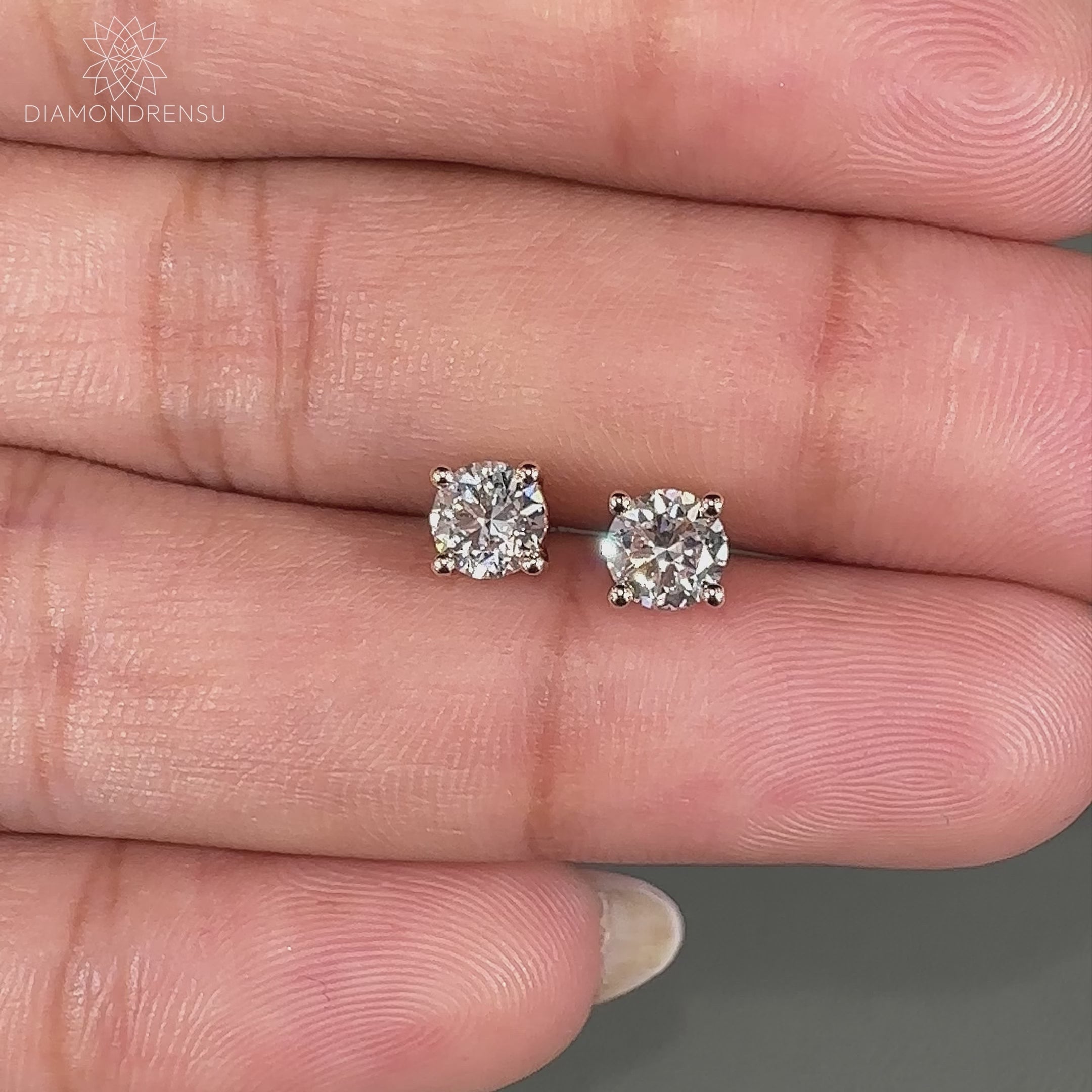 Handmade gold earrings featuring round diamond stud design.
