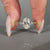 Oval diamond ring three stone style with filigree shank.

