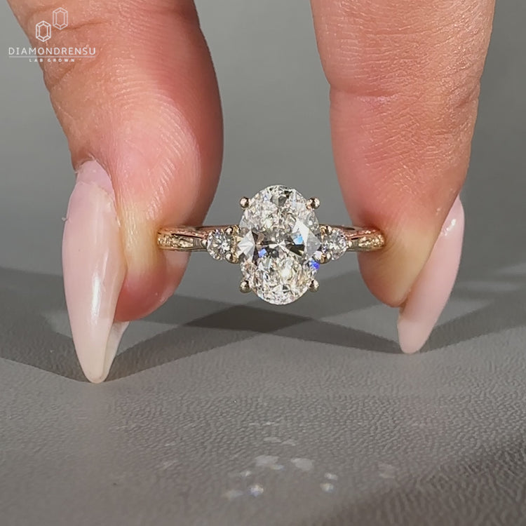 Oval diamond ring three stone style with filigree shank.
