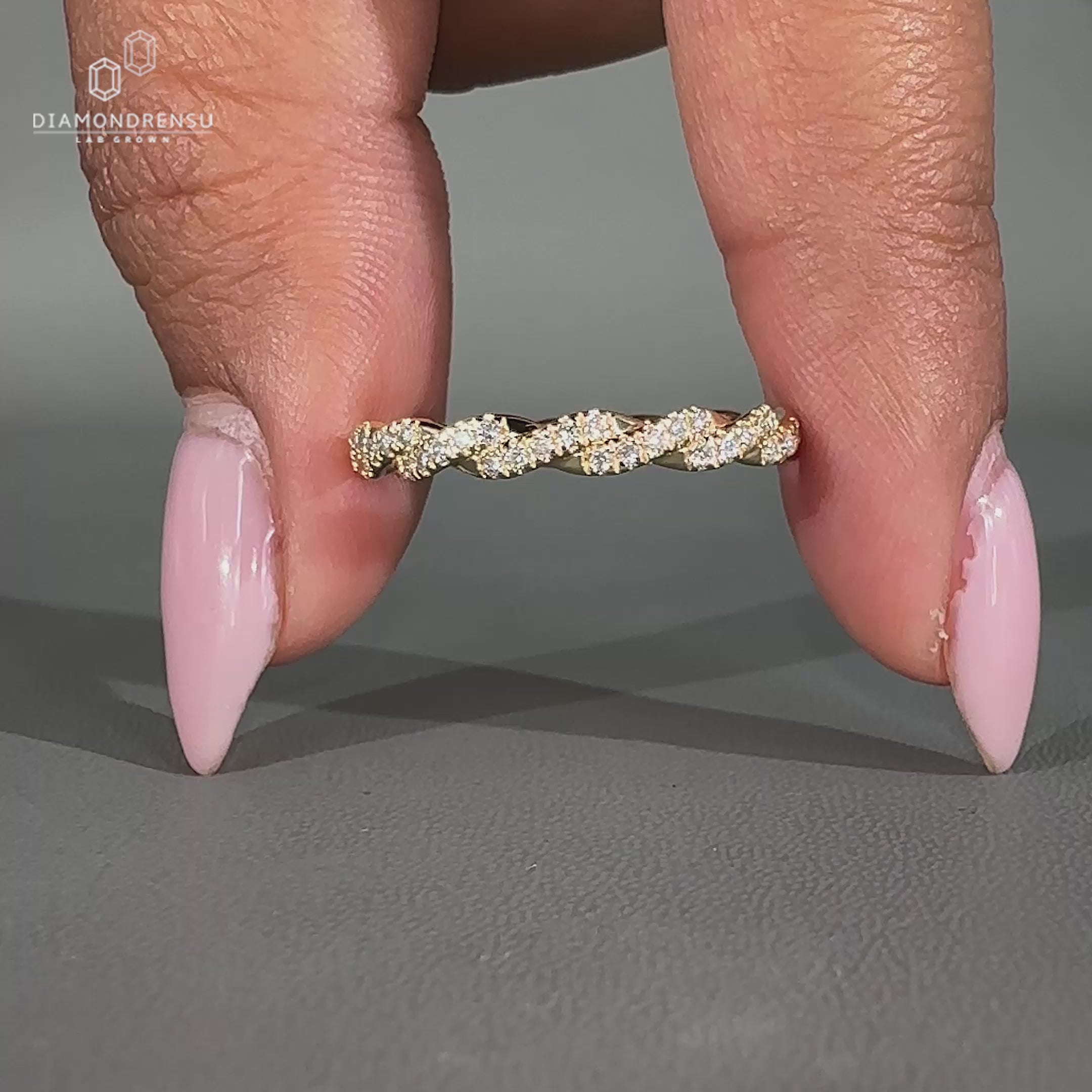 Yellow gold twist wedding band with diamonds.

