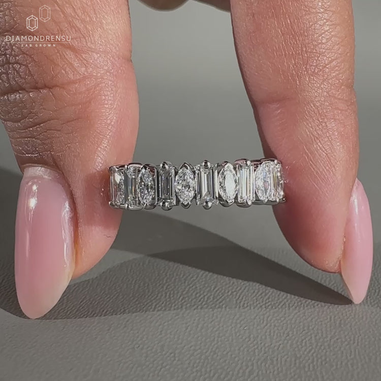 White gold eternity band with mixed diamond cuts.
