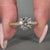Round cut diamond ring in yellow gold engagement ring style.
