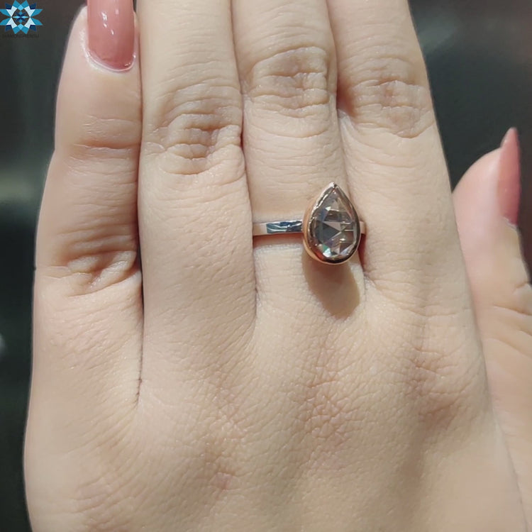 Elegant pear rose cut moissanite ring in two tone gold.
