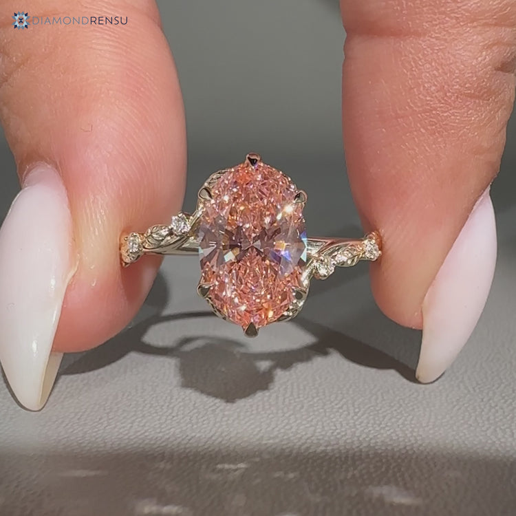 Pink centre diamond ring with nature inspired style.