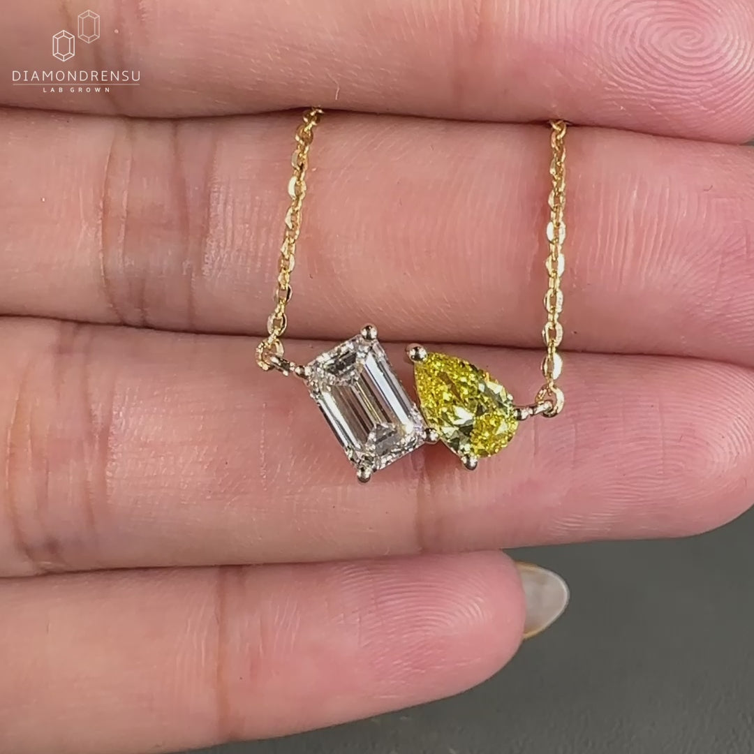 Yellow gold pendant crafted with emerald and pear cut Lab Grown Diamonds.
