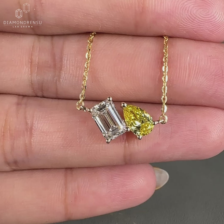 Yellow gold pendant crafted with emerald and pear cut Lab Grown Diamonds.
