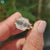 Emerald cut moissanite set with 2 trapezoid side stones in gold.
