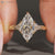 Art deco marquise ring with milgrain details and tulip setting.