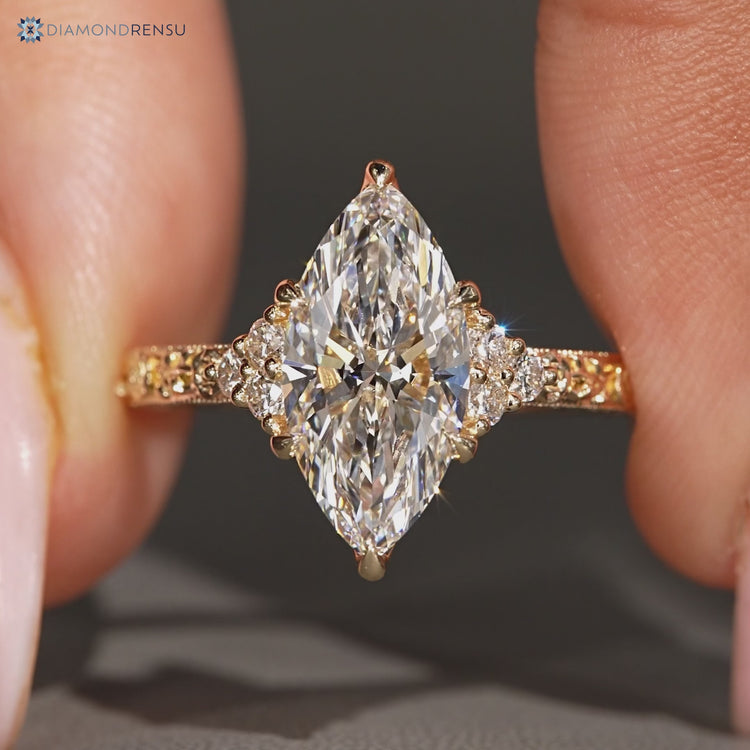 Art deco marquise ring with milgrain details and tulip setting.