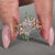 Nature inspired ring with six leaf style prong setting.