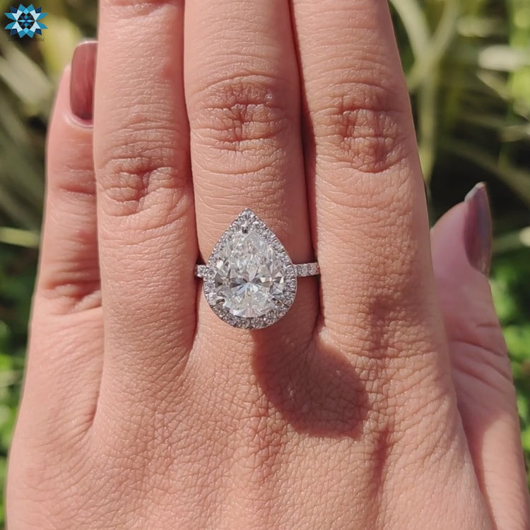 Diamondrensu UK teardrop halo moissanite ring.
