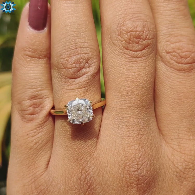 Yellow gold ring with cushion moissanite center stone.
