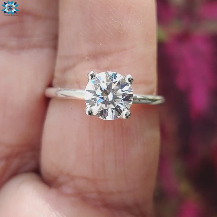 Minimal round cut moissanite ring in 4 prong design.
