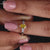 Pear diamond engagement ring in compass prong setting ring.
