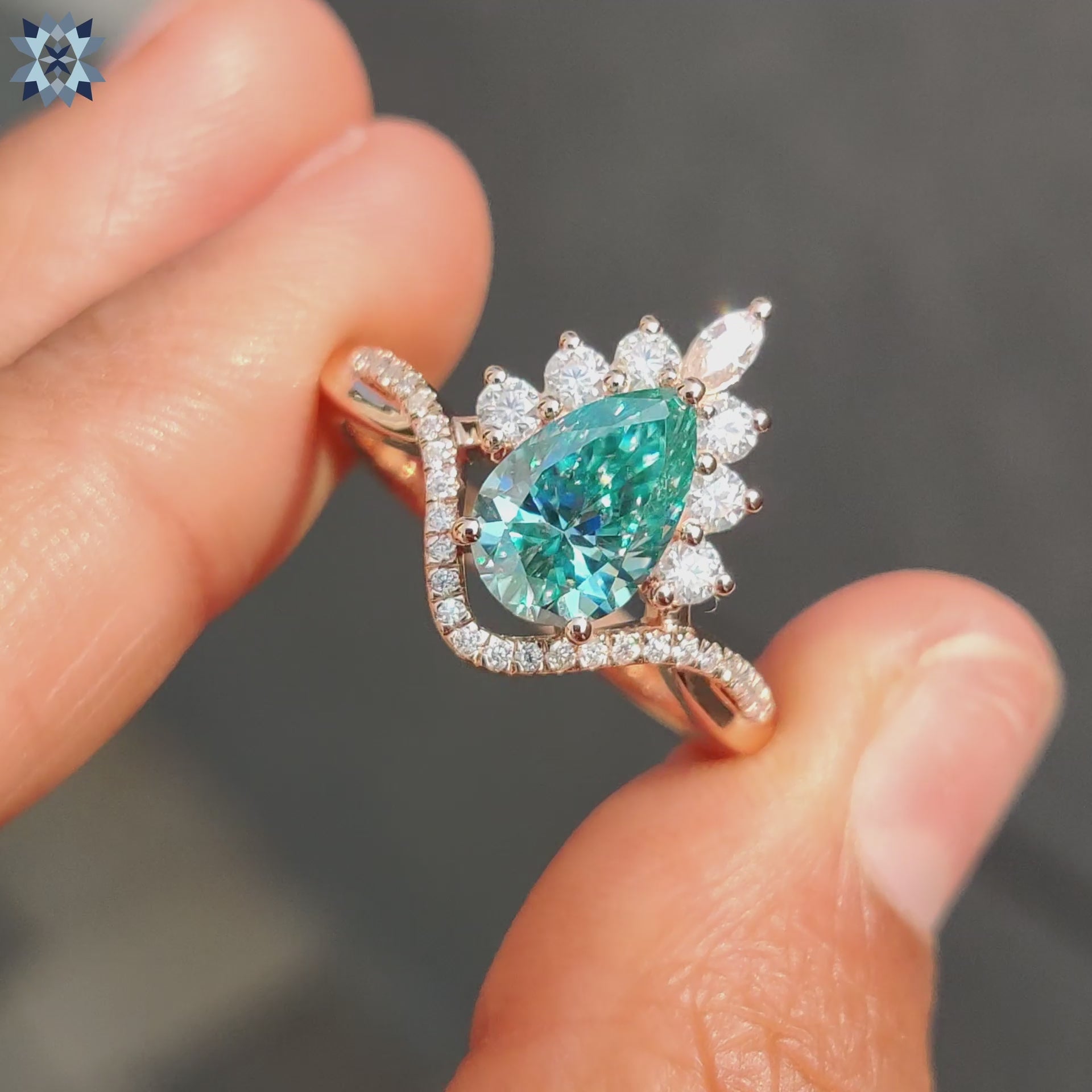 Twisted pave ring with cyan blue pear Moissanite in halo setting.
