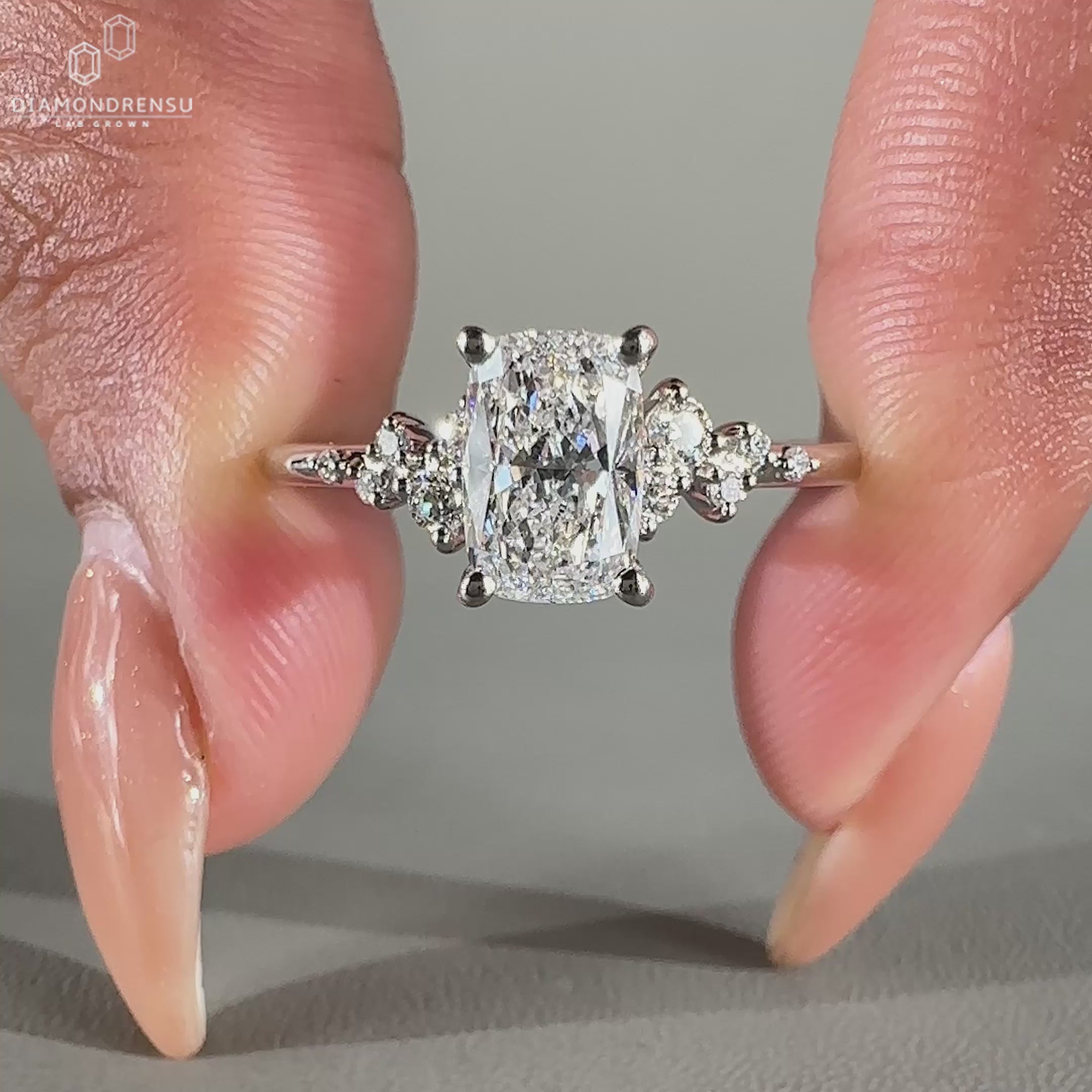 Snowdrift ring design featuring lab grown elongated cushion diamond.
