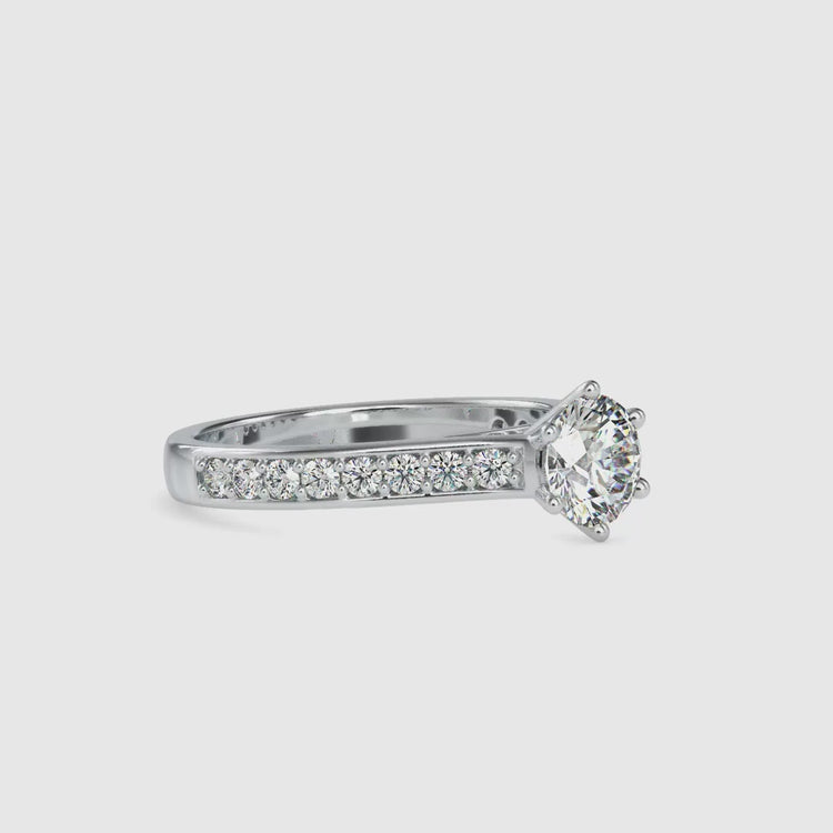 Round diamond engagement ring with side stones and custom setting.