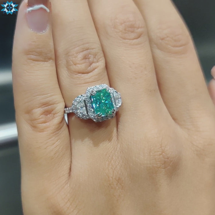 Blue center stone ring with half moon moissanite sides.
