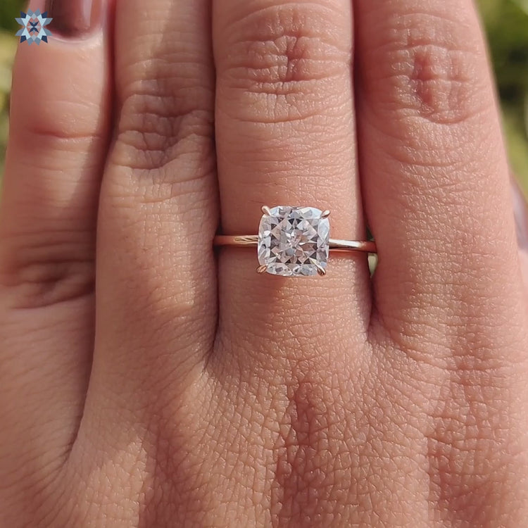 Custom engagement ring with a solitaire cushion Rensu cut stone.
