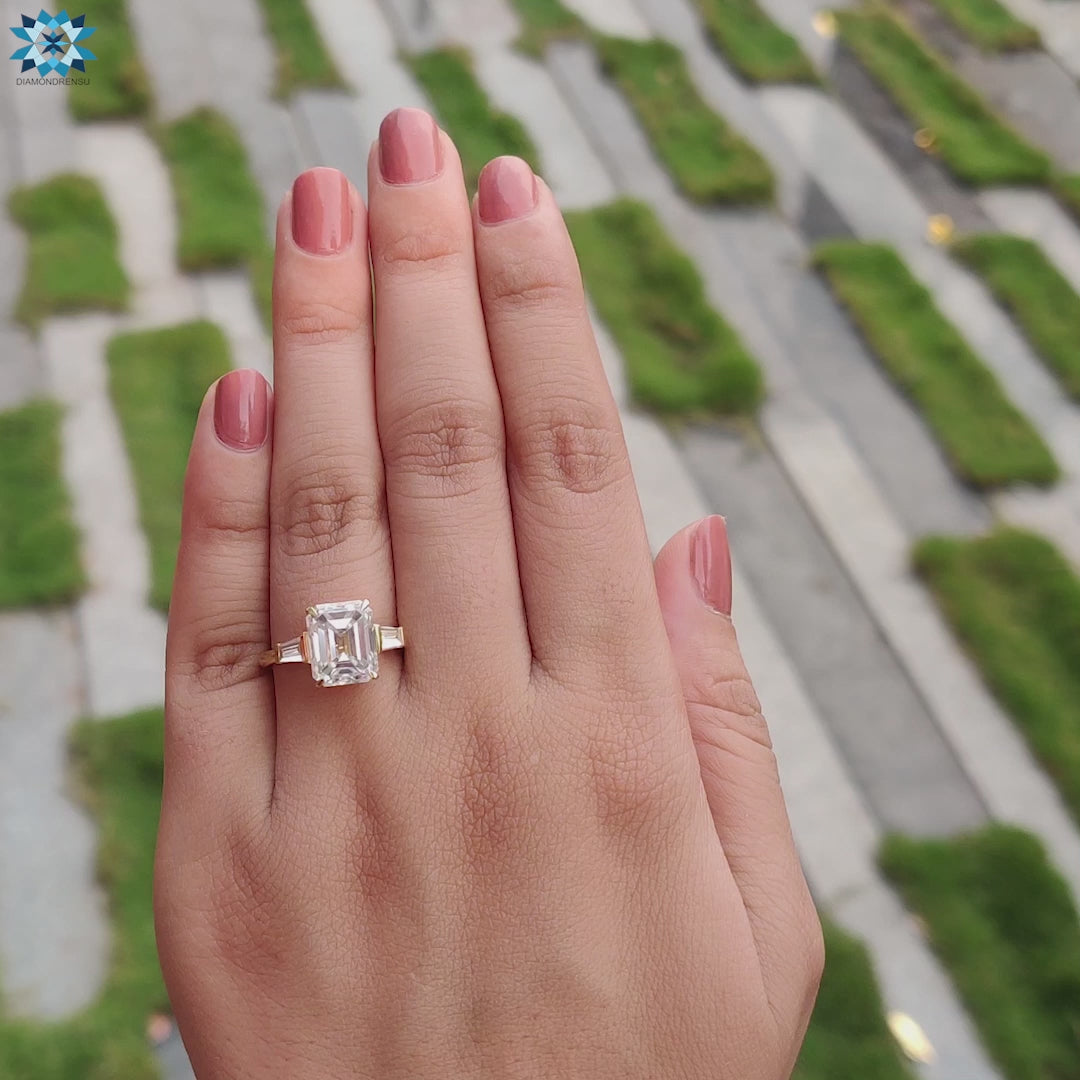 Moissanite Ring with tapered baguette ring accents and emerald cut centre stone.