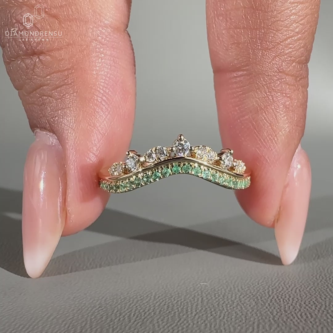 Tiara wedding band with green emeralds.
