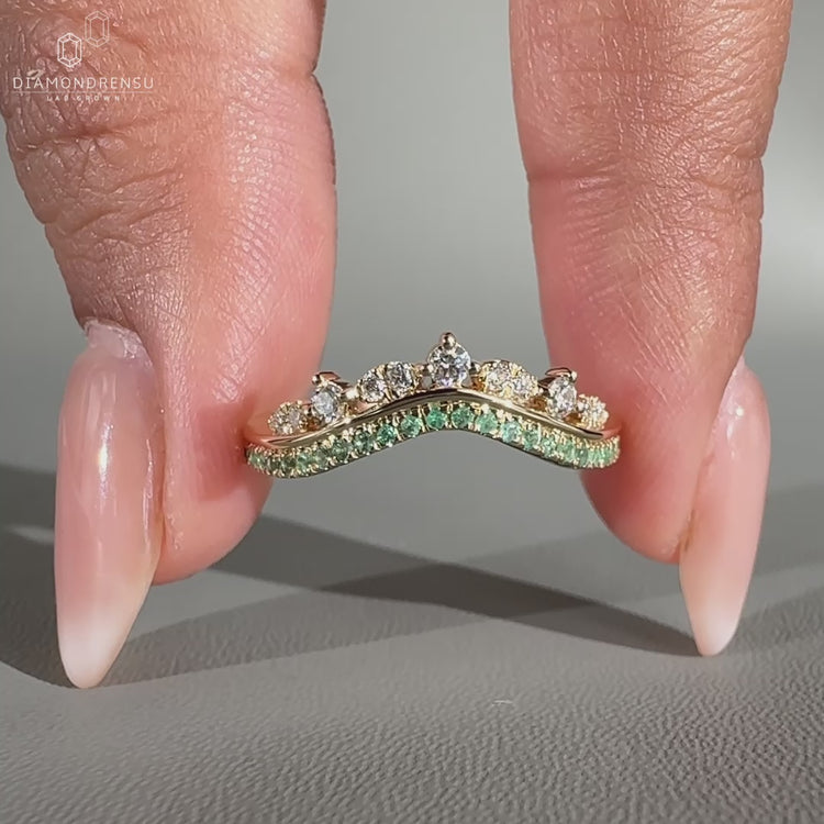 Tiara wedding band with green emeralds.
