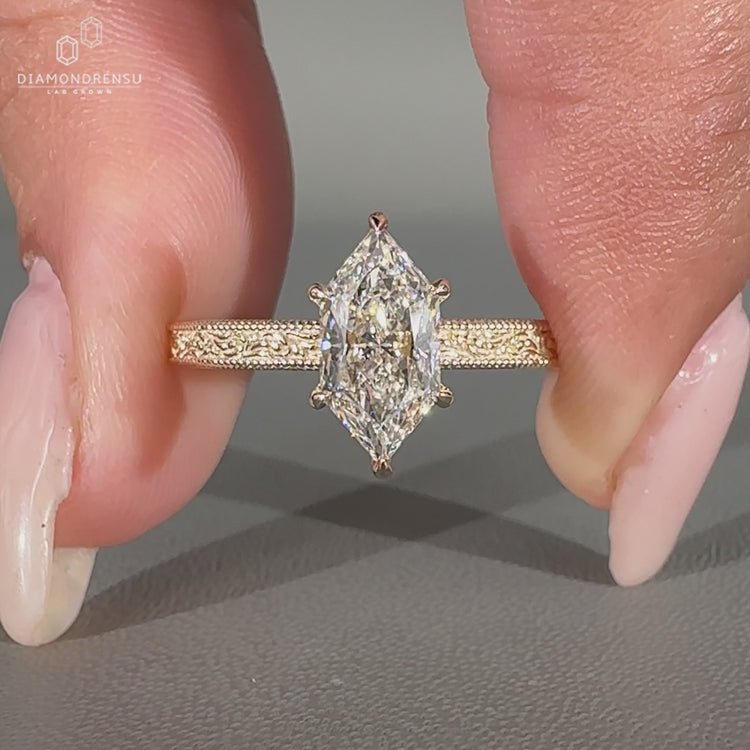Art deco marquise diamond ring with ocean wave design.