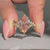 Pink centre diamond ring with marquise and round side stones.