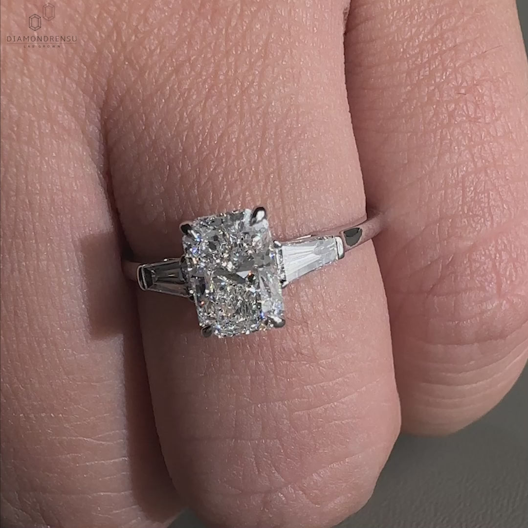 Three stone engagement ring diamond with a radiant centrepiece.
