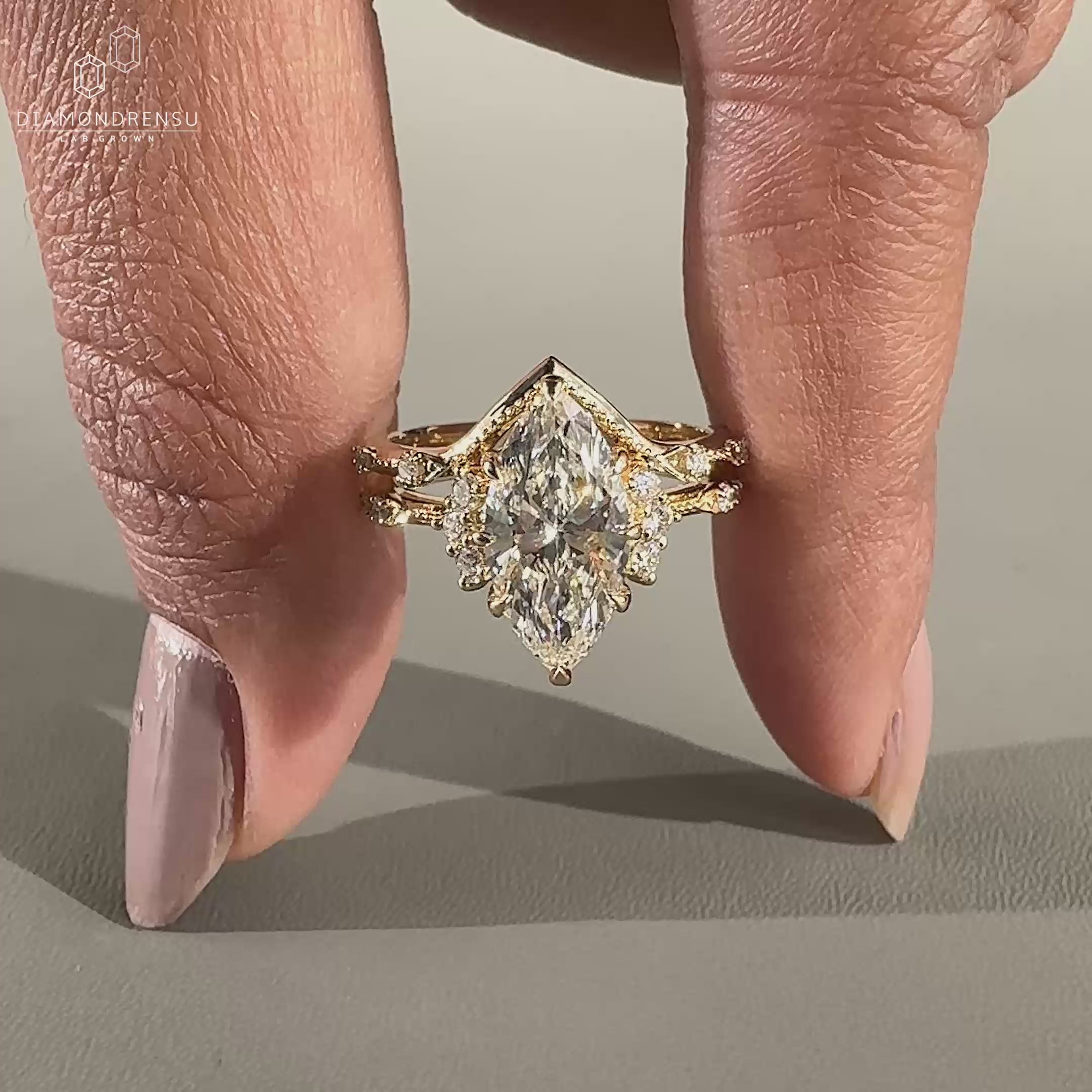 Marquise centre stone ring with vintage diamond ring and milgrain wedding band.
